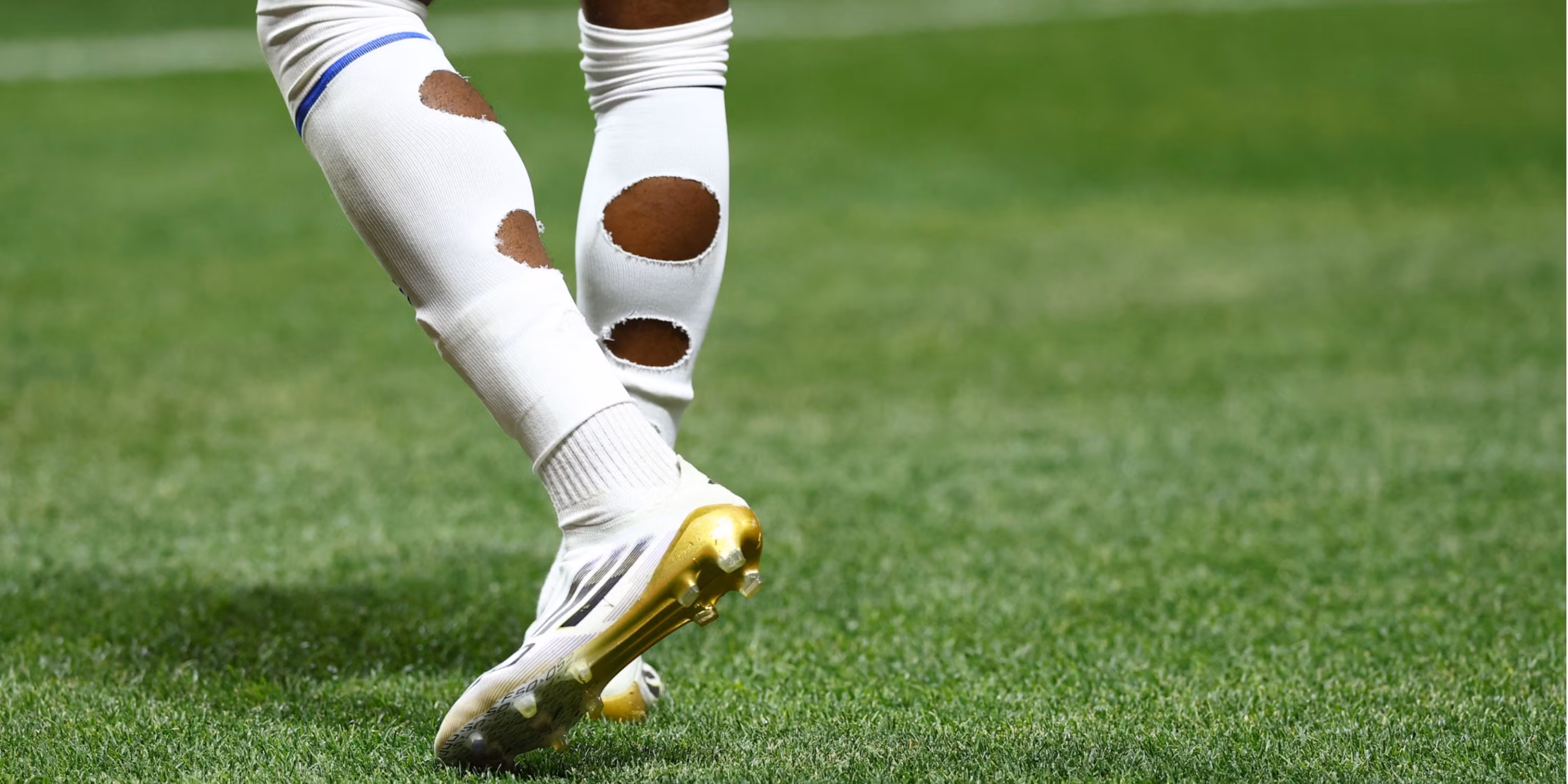 The Reason Why Footballers Cut Holes in Their Socks